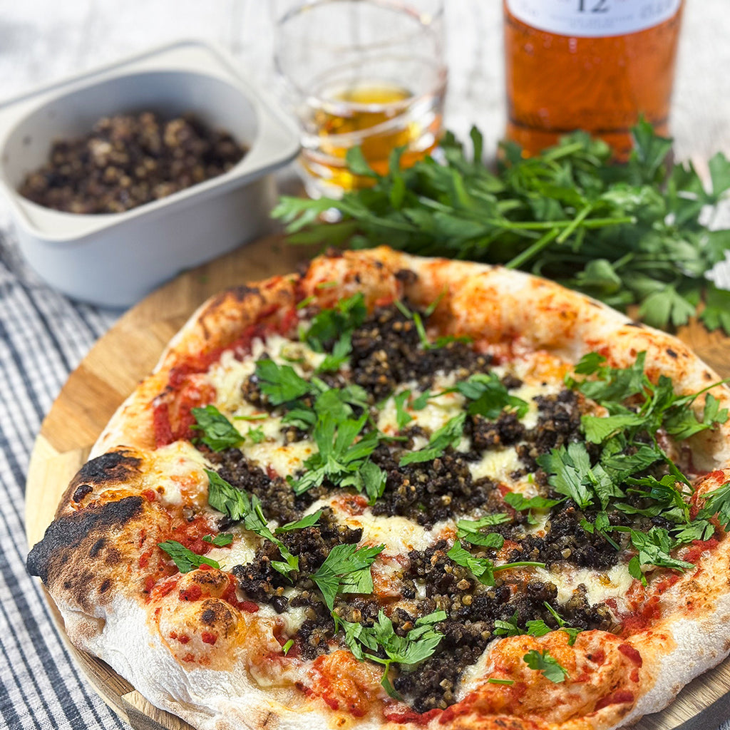 Haggis pizza served with a dram of whisky