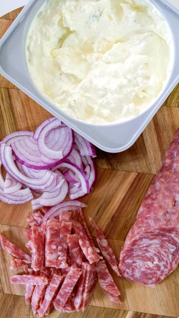 creme fraiche, sliced onion and sliced salami