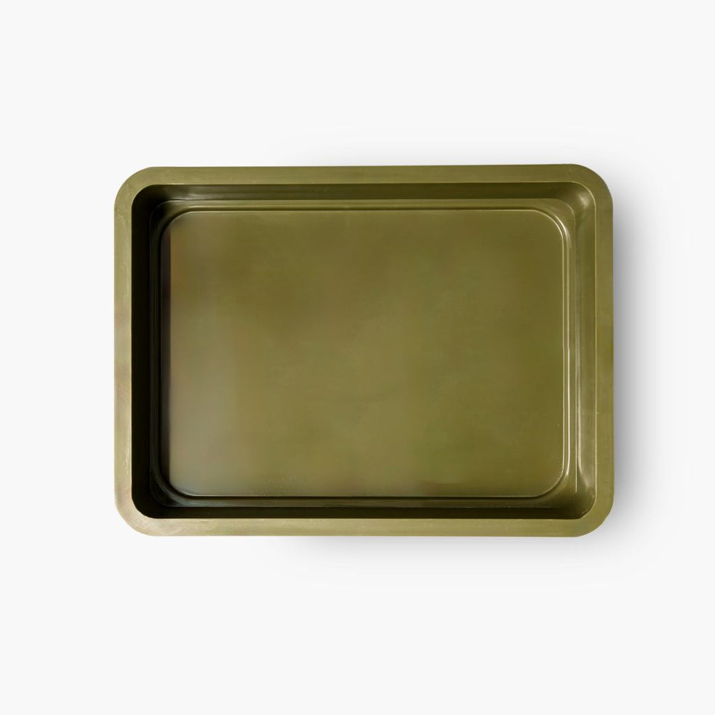 A top-down view of an empty olive-green dough tray with a smooth, glossy surface and slightly raised edges.