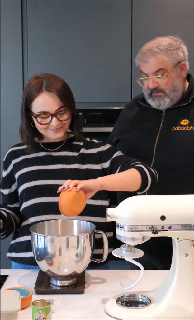 Kate adding salt to her dough mix