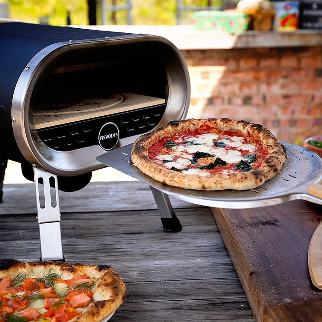 Revolve gas pizza oven, with a margerita pizza on a pizza peel