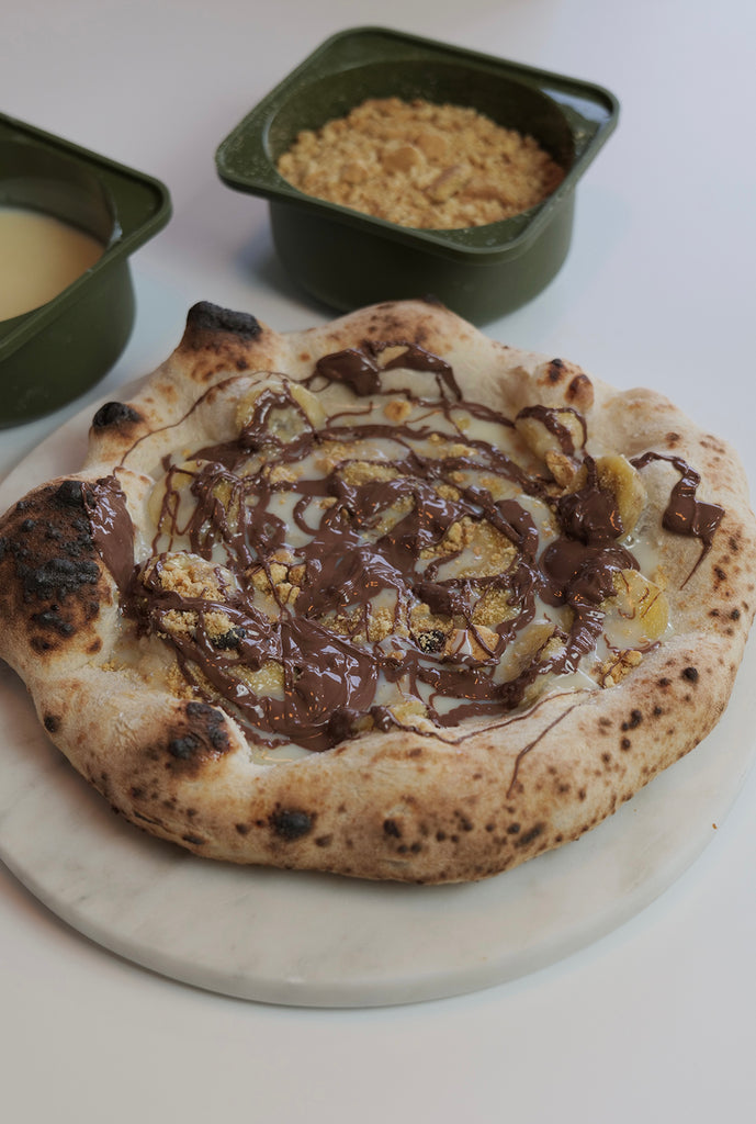 banoffee pizza with banana, condensed mild, crushed digestive biscuits and nutella