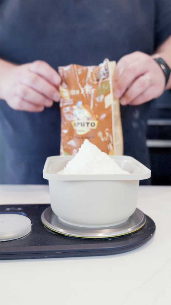 weighing gluten-free flour into a babadoh container